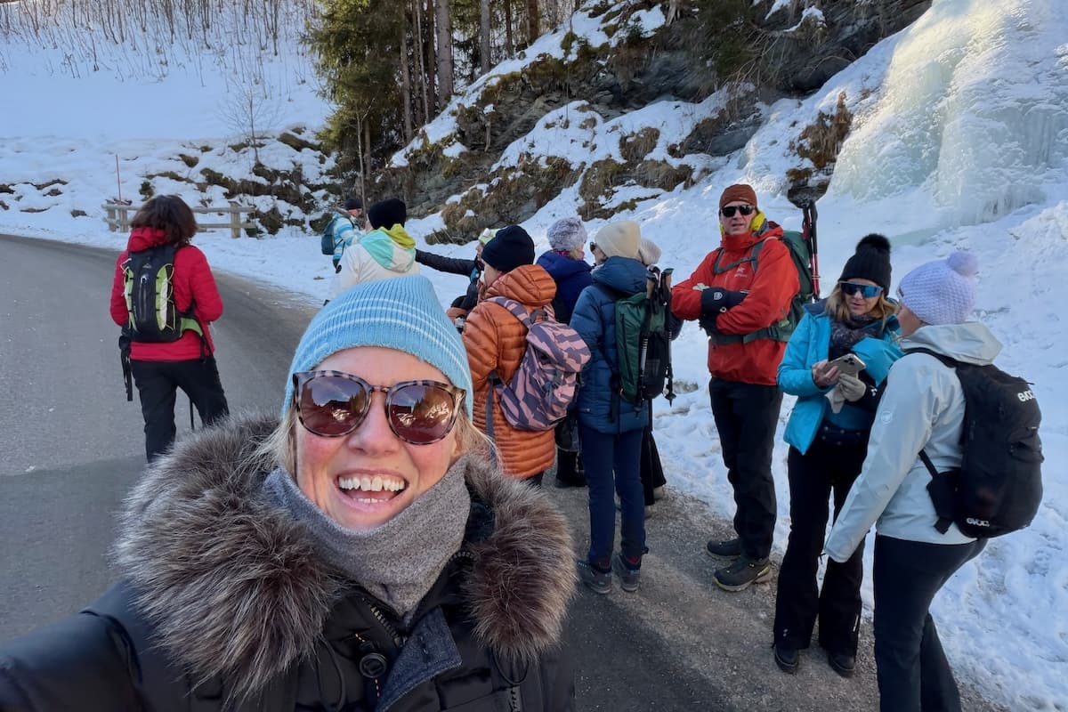 Group of winter hikers standing at snowy roadside