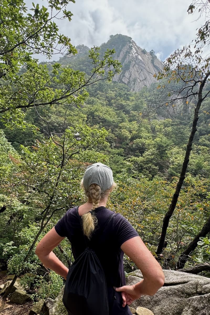 Woman looking at Bukhansan Mountain in the distance