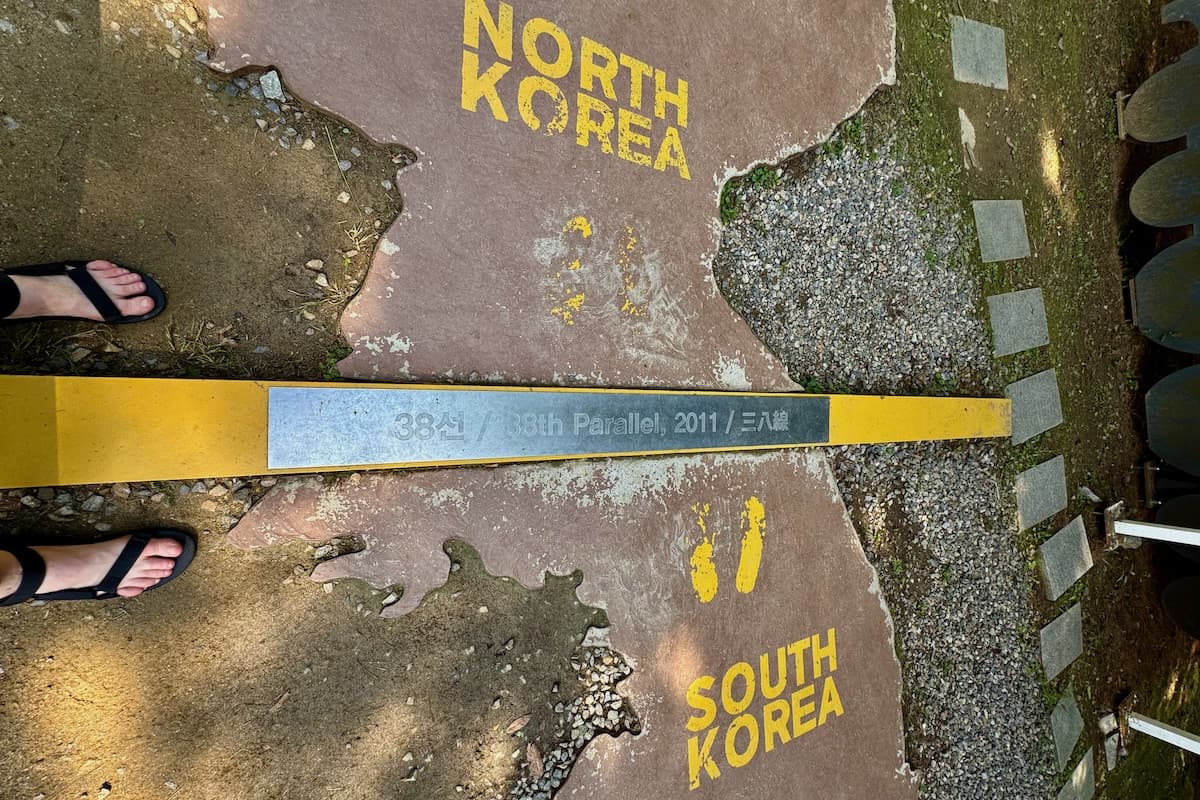Two feet standing each side of 38th parallel border of North and South Korea