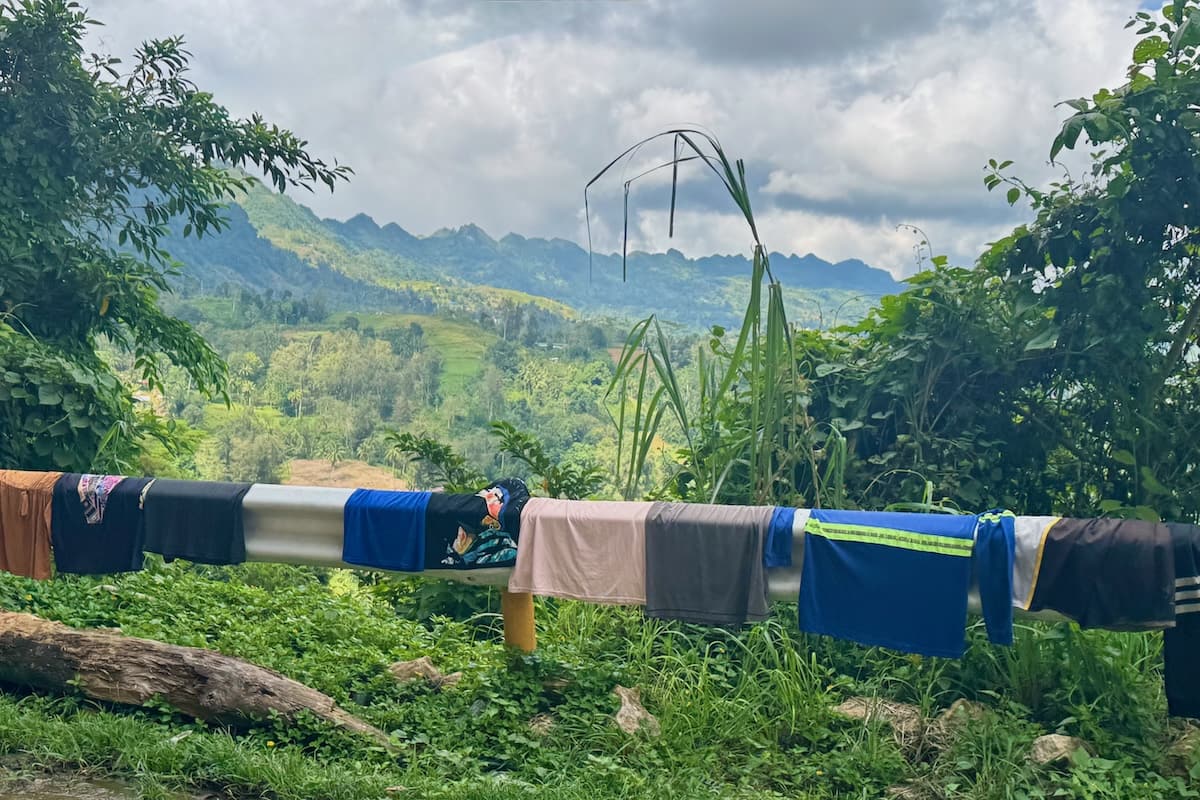 Clothes drying at roadside with mountains in distance in Philippines