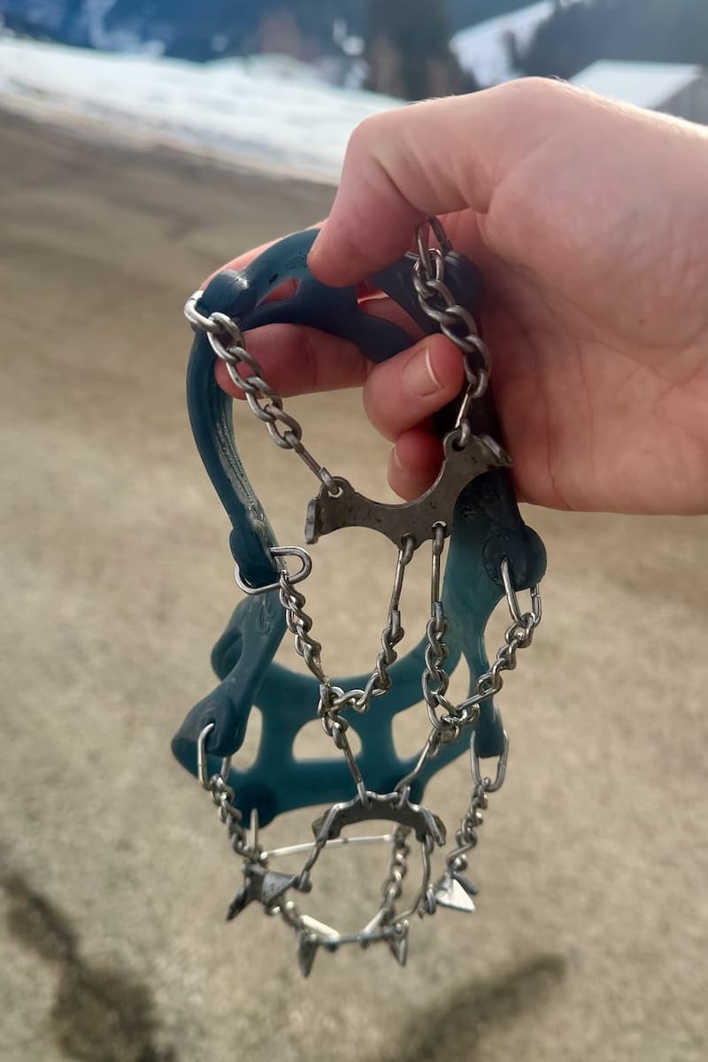 Hand holding crampons