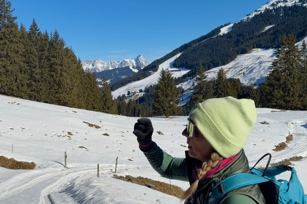 Certified Guide on Winter Hiking Trail with mountain views in background in Saalbach-Hinterglemm, Austria