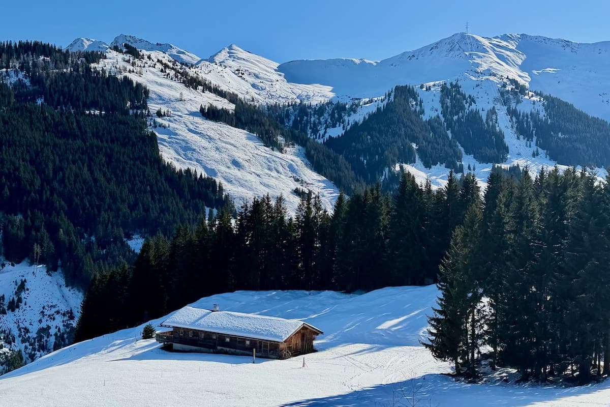Snow covered hut at base of mountain in Saalbach-hinterglemm, Austria