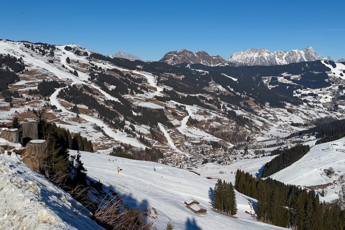 Panorama view of Saalbach-Hinterglemm in valley below in snow on a sunny day