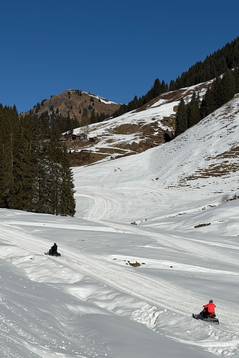 Snowmobiles racing in Saalbach-Hinterglemm, Austria on a sunny day