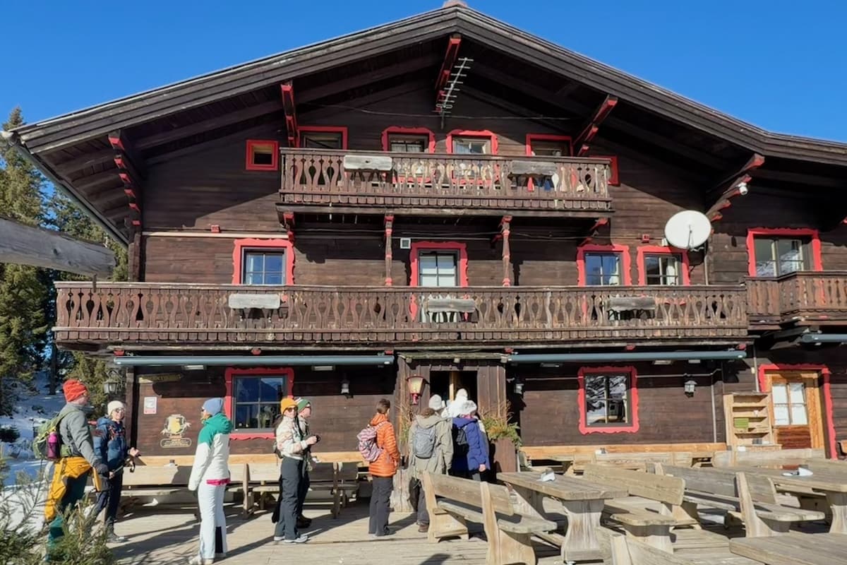 Winter hikers entering the Spielberghaus in Saalbach, Austria