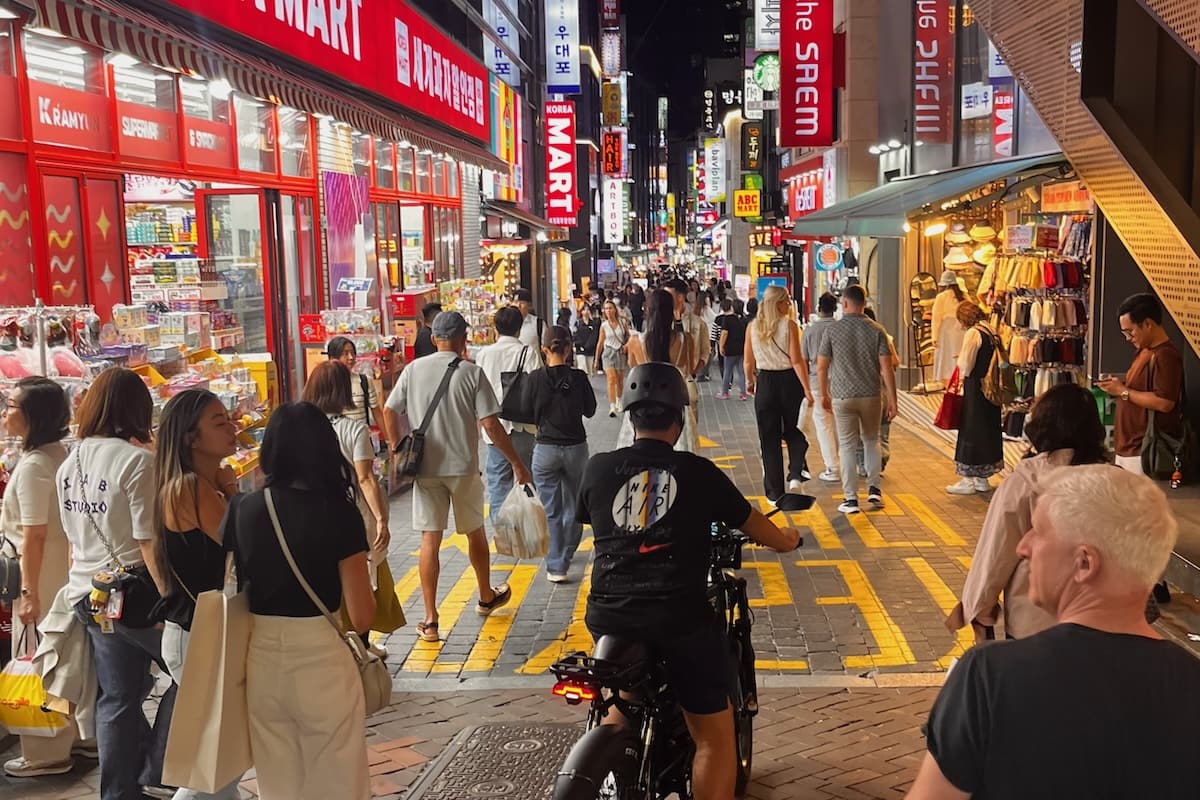 Busy pedestrian shopping street at night in Myeongdong, Seoul, Korea