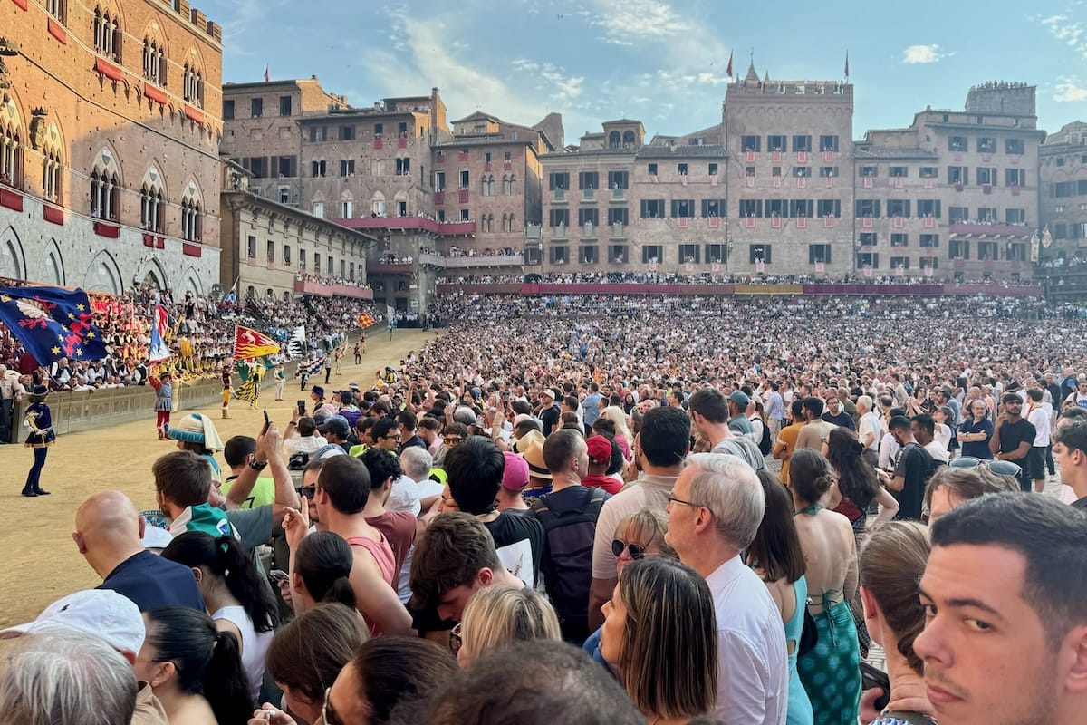 Crowd watching flags while waiting for Palio di Siena, Italy