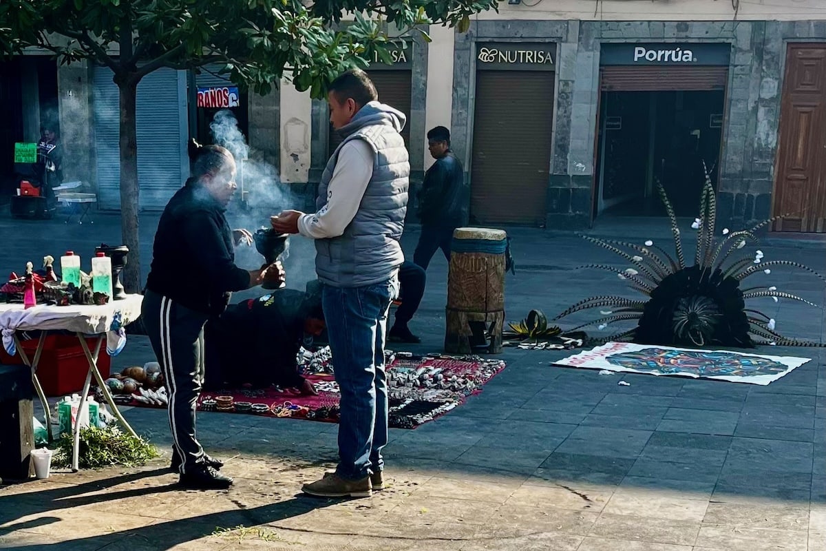 Man and woman in cleansing ceremony outside Metropolitan Cathedral in Mexico City