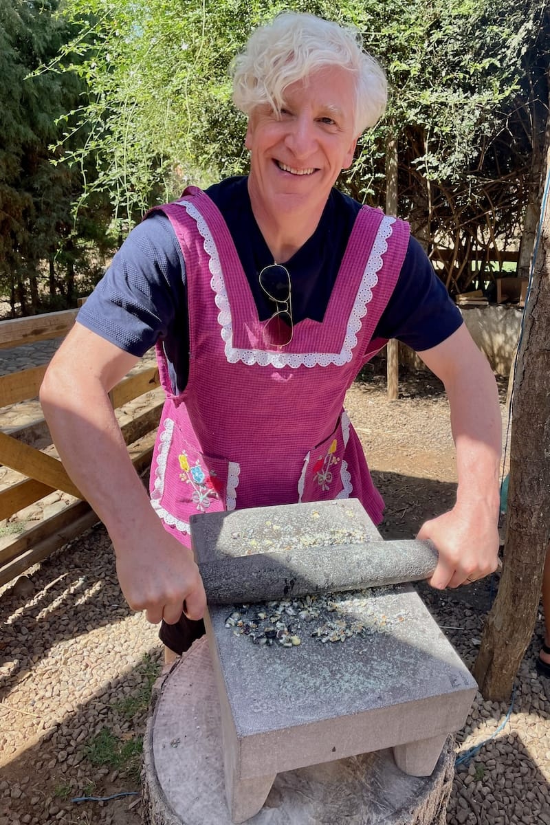 Grinding corn at cooking class in Oaxaca, Mexico