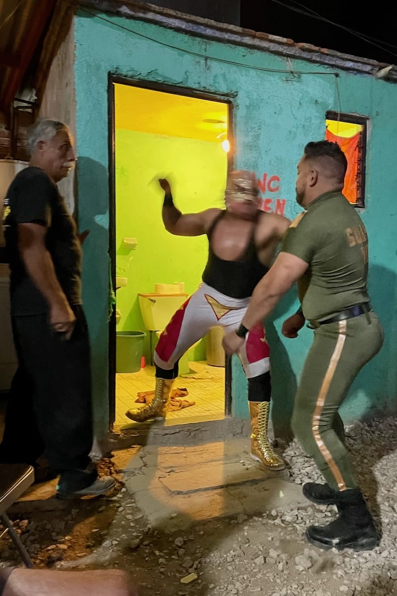 Luchadores crashing into toilet at Lucha Libre in Oaxaca, Mexico